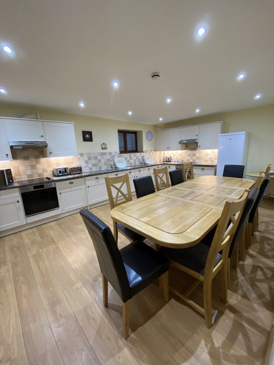 Large kitchen with a dining table in the barn